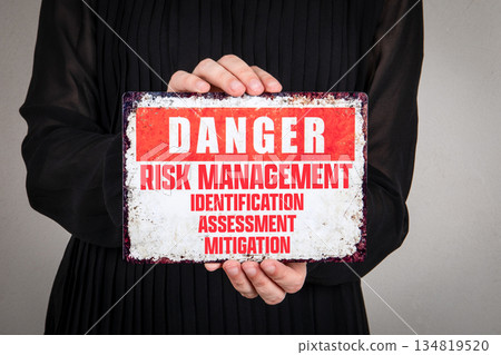 Danger Risk Management Identification Assessment Mitigation Warning Sign Held By Person Danger Risk Management Identification Assessment Mitigation Warning Sign Held By Person 134819520