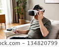 An elderly man wearing modern virtual reality glasses 134820799