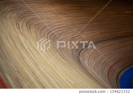 Very sharp turn with special wood surface. Taking turn on cycling track. Dangerous banked turn for maximum speed. Cycling competition. Closed circuit for bicycles with sharp turn 134821332