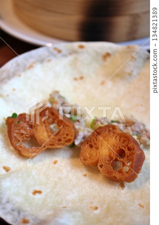 Chinese food: Chicken and fried bread wrapped in crepes Chinese food: Chicken and fried bread wrapped in crepes 134821389
