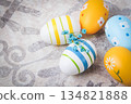 Easter. Multicolored eggs. Yellow and blue Easter decorations. 134821888
