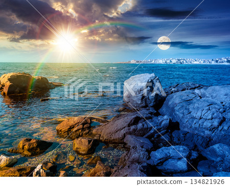 rocky shore of the sea coast under blue sky. day and night time change concept. beautiful view under sun and moon. resort scenery during vacation season in summer. harmony and progress calendar rocky shore of the sea coast under blue sky. day and night time change concept. beautiful view under sun and moon. resort scenery during vacation season in summer. harmony and progress calendar 134821926