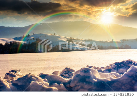 beautiful winter landscape with snow covered rolling hills under blue sky at sunset. majestic mountains in evening light. frosty countryside scenery. timeless nostalgia book cover with rainbow beautiful winter landscape with snow covered rolling hills under blue sky at sunset. majestic mountains in evening light. frosty countryside scenery. timeless nostalgia book cover with rainbow 134821930
