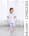 Cute little child playing with a jump rope at home, promoting active lifestyle 134822201