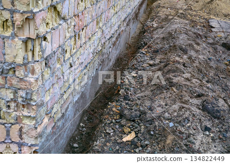 Preparing the building foundation for reinforcement by pouring concrete Preparing the building foundation for reinforcement by pouring concrete 134822449