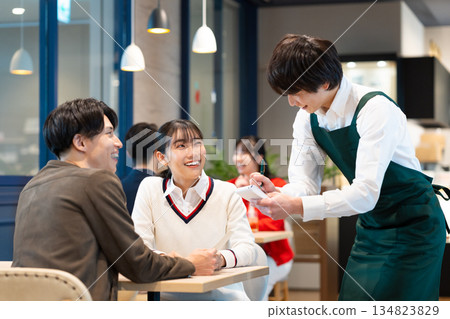 Young couple ordering at a cafe 134823829