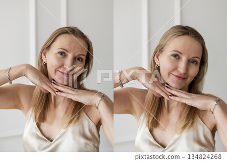 Beautiful natural woman posing with hands under chin in minimalist studio 134824268