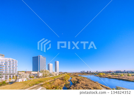 Tokyo cityscape, Japan, December 28th. Winter scenery of the Tama River and tower apartment buildings in front of Musashi-Kosugi Station. Towards a new era Tokyo cityscape, Japan, December 28th. Winter scenery of the Tama River and tower apartment buildings in front of Musashi-Kosugi Station. Towards a new era 134824352