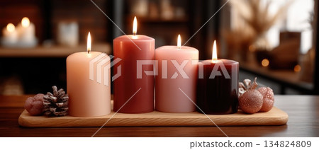 Decorative holiday arrangement with candles, ornaments, and pinecones set against a soft, glowing background Decorative holiday arrangement with candles, ornaments, and pinecones set against a soft, glowing background 134824809