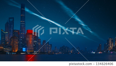 Night starry sky above Shanghai Skyscrapers. reflection of Shanghai's skyscrapers amidst bustling urban life at evening. Night starry sky above Shanghai Skyscrapers. reflection of Shanghai's skyscrapers amidst bustling urban life at evening. 134826406
