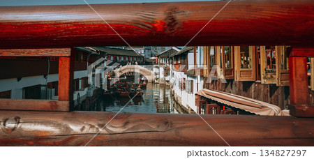 Framed view of a canal bridge with traditional houses and scenic reflections. Zhujiajiao, Shanghai, China Framed view of a canal bridge with traditional houses and scenic reflections. Zhujiajiao, Shanghai, China 134827297