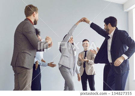 Office Team Celebrating Success, Applauding and Dancing During Business Meeting Office Team Celebrating Success, Applauding and Dancing During Business Meeting 134827355