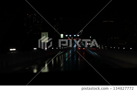 Highway passing under a bridge at night Highway passing under a bridge at night 134827772