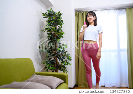 Japanese woman in yoga wear heading to training gym, yoga studio, yoga mat, leggings Japanese woman in yoga wear heading to training gym, yoga studio, yoga mat, leggings 134827880