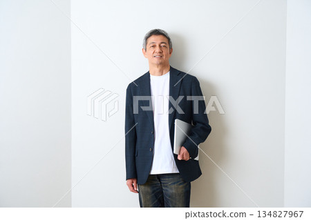 Senior man standing in a jacket and jeans Senior man standing in a jacket and jeans 134827967