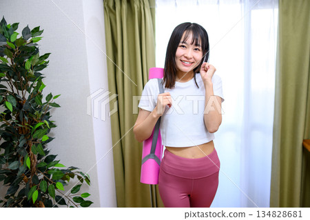 Japanese woman in yoga wear heading to training gym, yoga studio, yoga mat, leggings Japanese woman in yoga wear heading to training gym, yoga studio, yoga mat, leggings 134828681