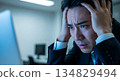 A man holding his head in despair after suddenly seeing a blue screen. Copy space. 134829494