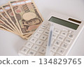 Calculator, pen and 10,000 yen sign_diagonal 134829765