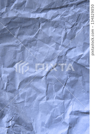 Crumpled blue paper texture with natural folds, soft shadows and organic surface detail for abstract backgrounds and design use Crumpled blue paper texture with natural folds, soft shadows and organic surface detail for abstract backgrounds and design use 134829850