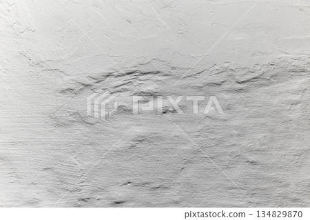 White plaster wall texture with horizontal relief, soft shadows and minimal neutral background. Copy space 134829870