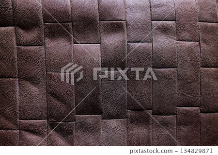 Dark brown woven leather wall texture with geometric padded pattern and luxury background. Copy space Dark brown woven leather wall texture with geometric padded pattern and luxury background. Copy space 134829871