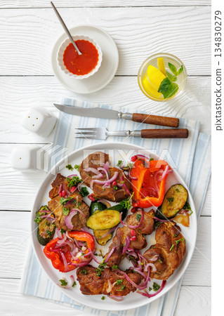 Grilled pork neck chunks with roasted veggies 134830279