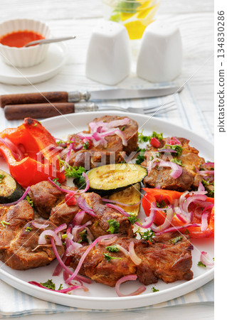 Grilled pork neck chunks with roasted veggies 134830286