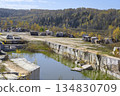 Huge geometric stone shapes and autumn birches reflected in the water of the abandoned marble quarry 134830709
