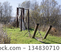 Iron pipes and cables of a suspension bridge in the village of Peteni in Siberia 134830710