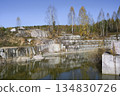 Huge cubic and geometric stone shapes are reflected in the water of the abandoned arble quarry 134830726