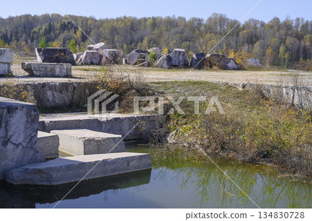 Huge cubic and geometric stone shapes in an abandoned Peteni marble quarry in Siberia Huge cubic and geometric stone shapes in an abandoned Peteni marble quarry in Siberia 134830728