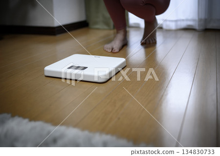 Feet of a Japanese woman in yoga wear looking at a scale Diet leggings Color reduction 134830733
