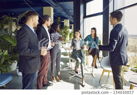 Businesswoman Conducting Meeting For Team Of Colleagues In The Office 134830857
