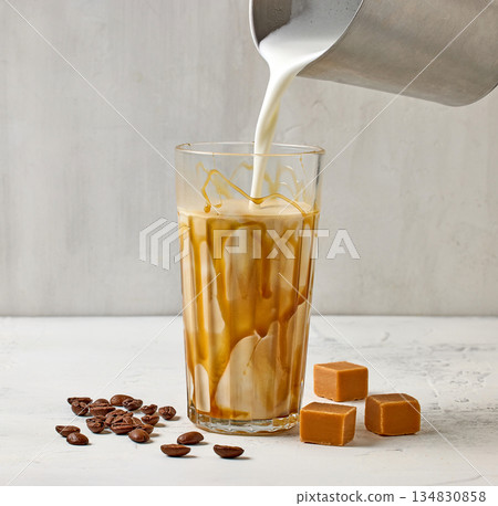 closeup of caramel latte coffee glass on white table background 134830858