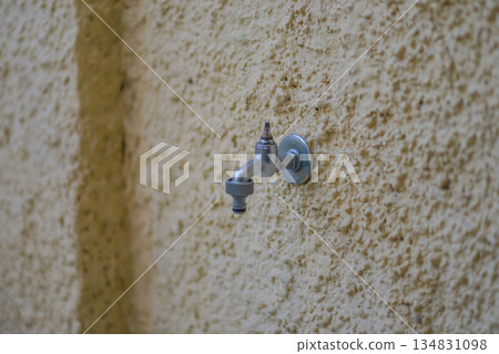 Outdoor Water Faucet on Textured Wall Outdoor Water Faucet on Textured Wall 134831098