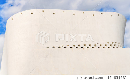 Geometric orange building design. Modern architecture. Geometric shape. Modern building architecture against blue sky. Architectural geometrical detail. Exterior and facade Geometric orange building design. Modern architecture. Geometric shape. Modern building architecture against blue sky. Architectural geometrical detail. Exterior and facade 134831381