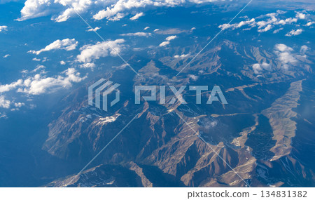 Aerial cloudy view. Landscape from plane. Top of mountain in cloud. Landscape with mountain in cloudy nature. Cloud and mountain peak aerial view. Travel concept. Aerial view of mountain landscape Aerial cloudy view. Landscape from plane. Top of mountain in cloud. Landscape with mountain in cloudy nature. Cloud and mountain peak aerial view. Travel concept. Aerial view of mountain landscape 134831382