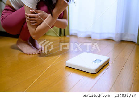 Woman in yoga wear shocked at scale, diet, leggings 134831387