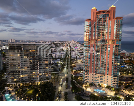 Night city aerial view. Luxury skyscraper in Miami, Florida. City skyline in evening. Aerial cityscape. Miami South beach night light. Aerial view on skyscraper cityscape at night. Residential hotel 134831393