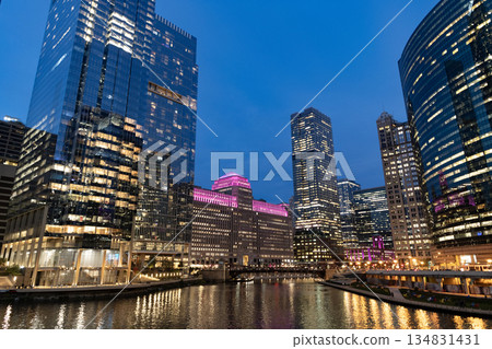 Chicago architecture of skyscraper at river. City night illuminated building. Skyscraper cityscape. Night city of Chicago, Illinois. Business city. Night cityscape of Chicago skyscraper building 134831431