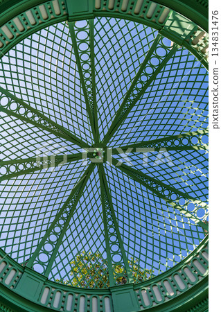 Architectural detail. Iron roof design of gazebo. Iron framed ceiling roof of alcove. Detailed architecture. Iron structure dome background. Dome roof Architectural detail. Iron roof design of gazebo. Iron framed ceiling roof of alcove. Detailed architecture. Iron structure dome background. Dome roof 134831476