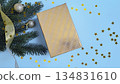 Golden gift box with fir branches on a blue background 134831610