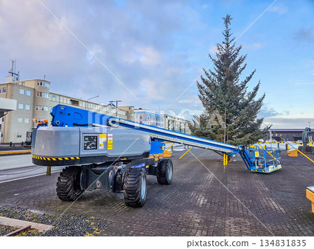 Installing Christmas Tree in City Square Using Aerial Lift Installing Christmas Tree in City Square Using Aerial Lift 134831835