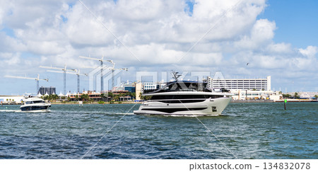 Luxury boat motor yacht in marina. Luxury yacht heading out to sea from marina. Boating and yachting tourism. Luxury lifestyle. Vacations on summer. Yacht at sea. Sea vacation on summer. Miami port 134832078