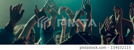 Silhouettes of dancing people under warm colorful lights. Banner 134832115