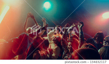 Expressive crowd movement during night music event. 134832117