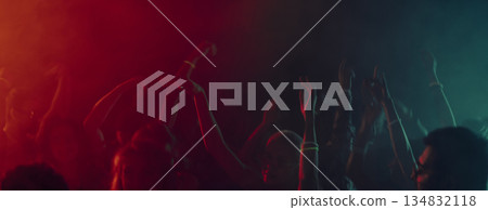 Abstract motion of dancing hands in colorful light haze. Banner 134832118