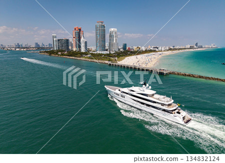 Luxury yacht cruising near Miami skyline. Aerial view of boats on turquoise waters in Miami. Yacht retreat in South Florida Miami. 134832124