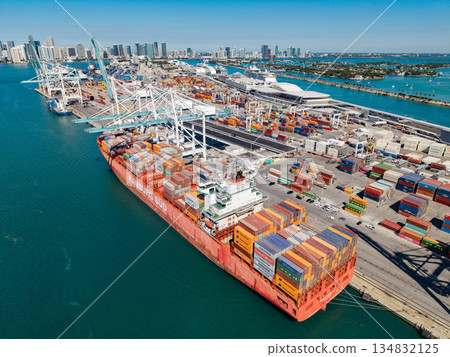 Miami, Florida, USA - March 20, 2025: Cargo ship vessel. Miami port. Container export ship. Cargo Hamburg Sud ship services with container in Miami, aerial view. Freight container on cargo vessel 134832125