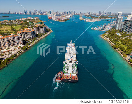 Miami, Florida, USA - March 20, 2025: Container Monrovia ship. Cargo Seaboard Explorer container ship, import. Freight container cargo vessel and tugboat. Cargo ship vessel. Miami port 134832126